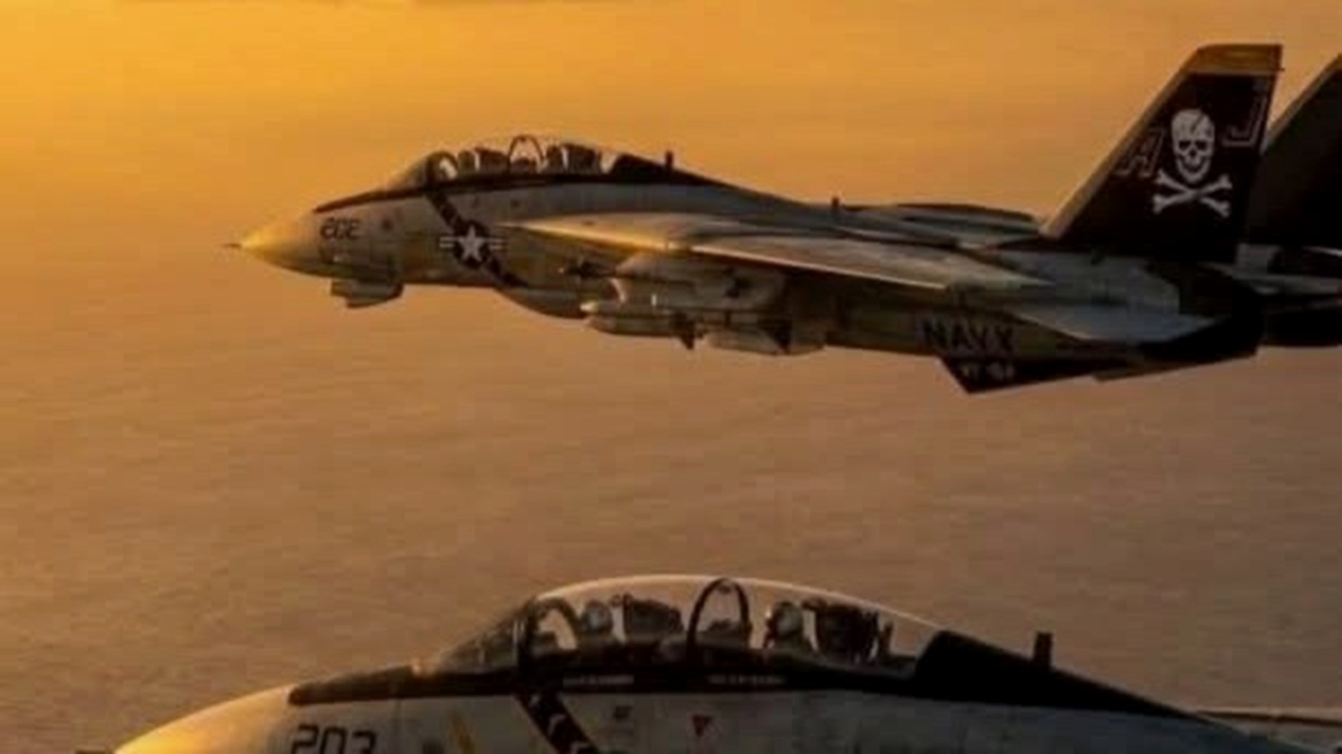 Two naval fighter aircraft in flight at sunset — illustrative defense aviation image